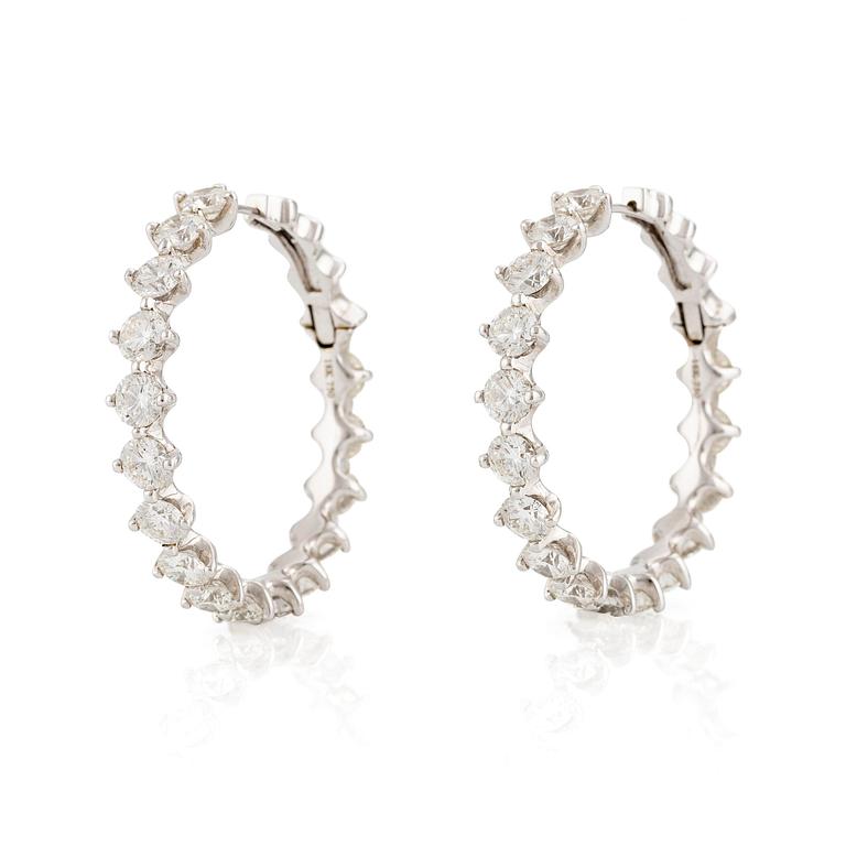 A pair of earrings in 18K white gold set with round brilliant-cut diamonds.