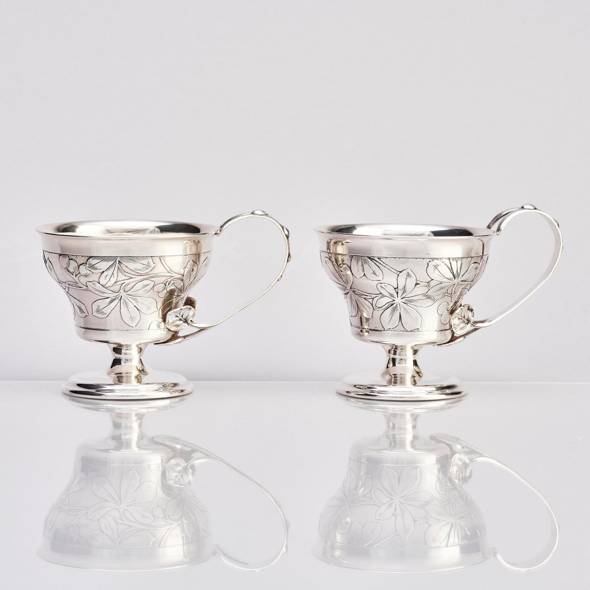 Teodor Werner & Co, ett par tekoppar med fat och skedar, silver, sannolikt Warzawa, 1899-1904.