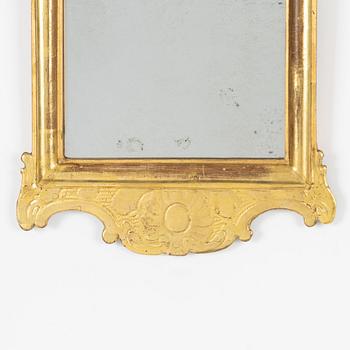 A giltwood rococo mirror by J. Schürer (master in Stockholm 1769).