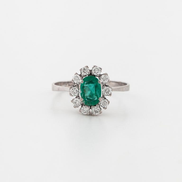 A emerald and brilliant cut diamond ring.