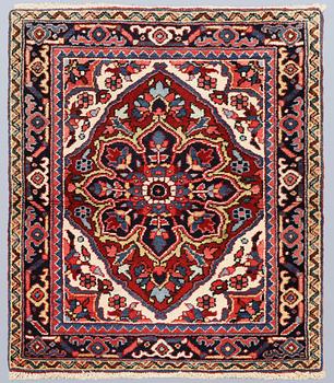 A semi-antique Heris rug, approx. 90 x 78 cm.