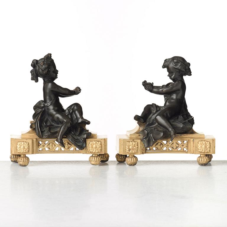 A pair of Louis XVI late 18th century fire dogs.