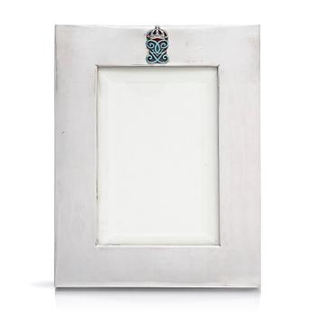 309. A silver and enamel frame with glass, mark of CG Hallberg, Stockholm 1935.