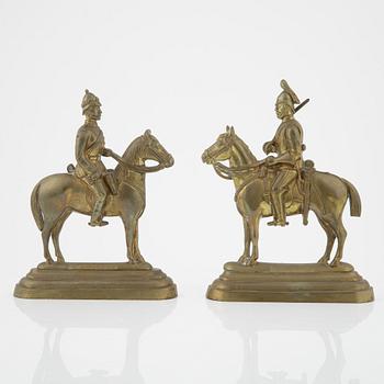 A pair of brass book stands,