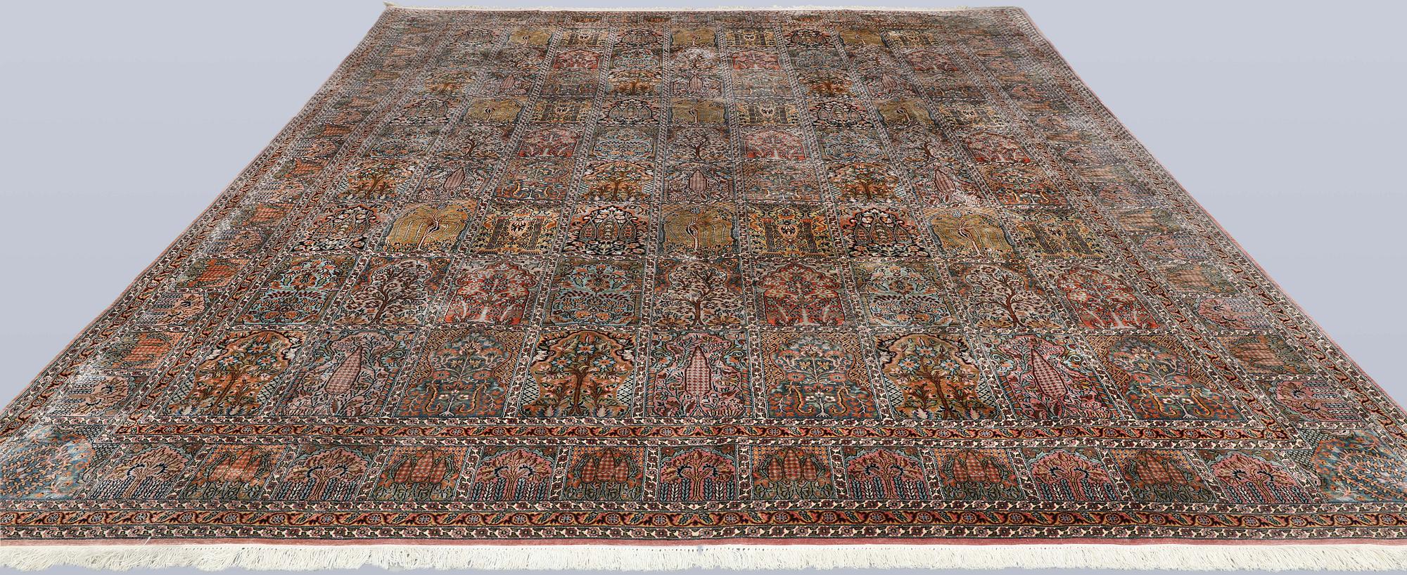 A Kashmir silk carpet, 418 x 297 cm.