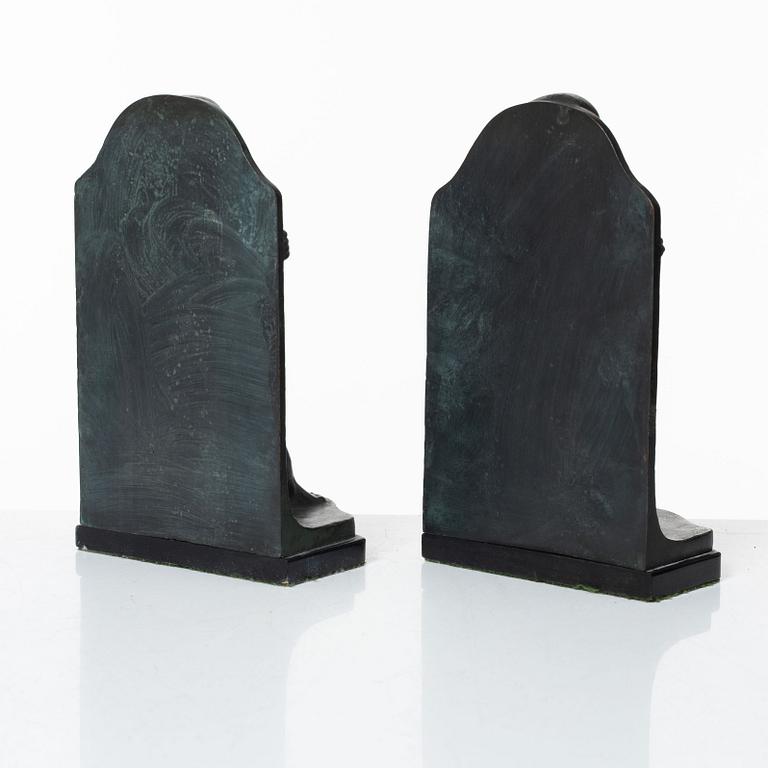 Axel Gute, a pair of patinated bronze bookends, dated 1920.
