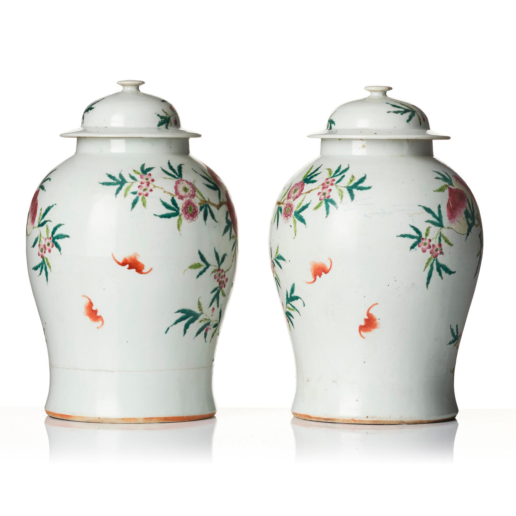 A pair of Chinese famille rose peach vases with covers, late Qing dynasty/circa 1900.