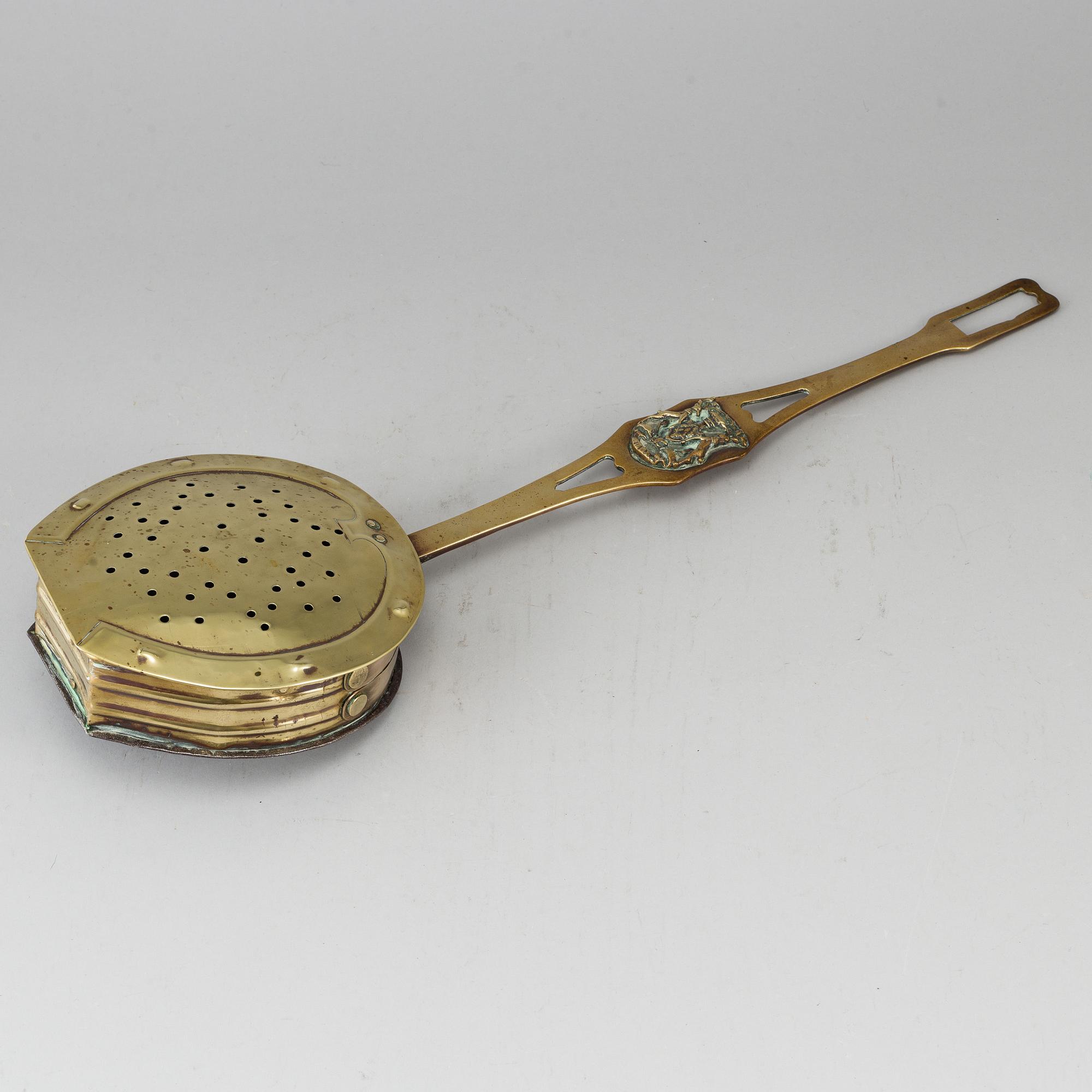 A brass chestnut roaster, 19th century.