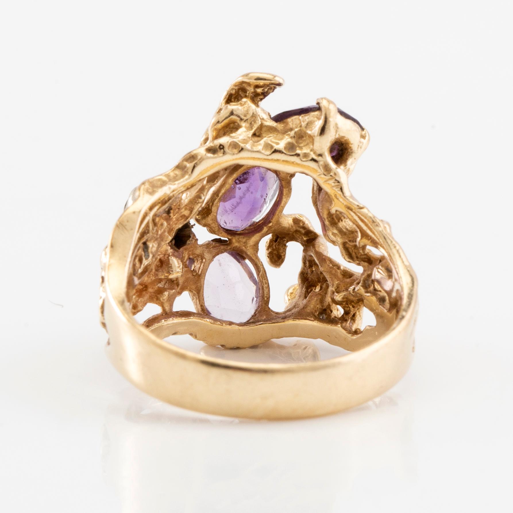 14K gold ring with amethysts and a round brilliant-cut diamond.
