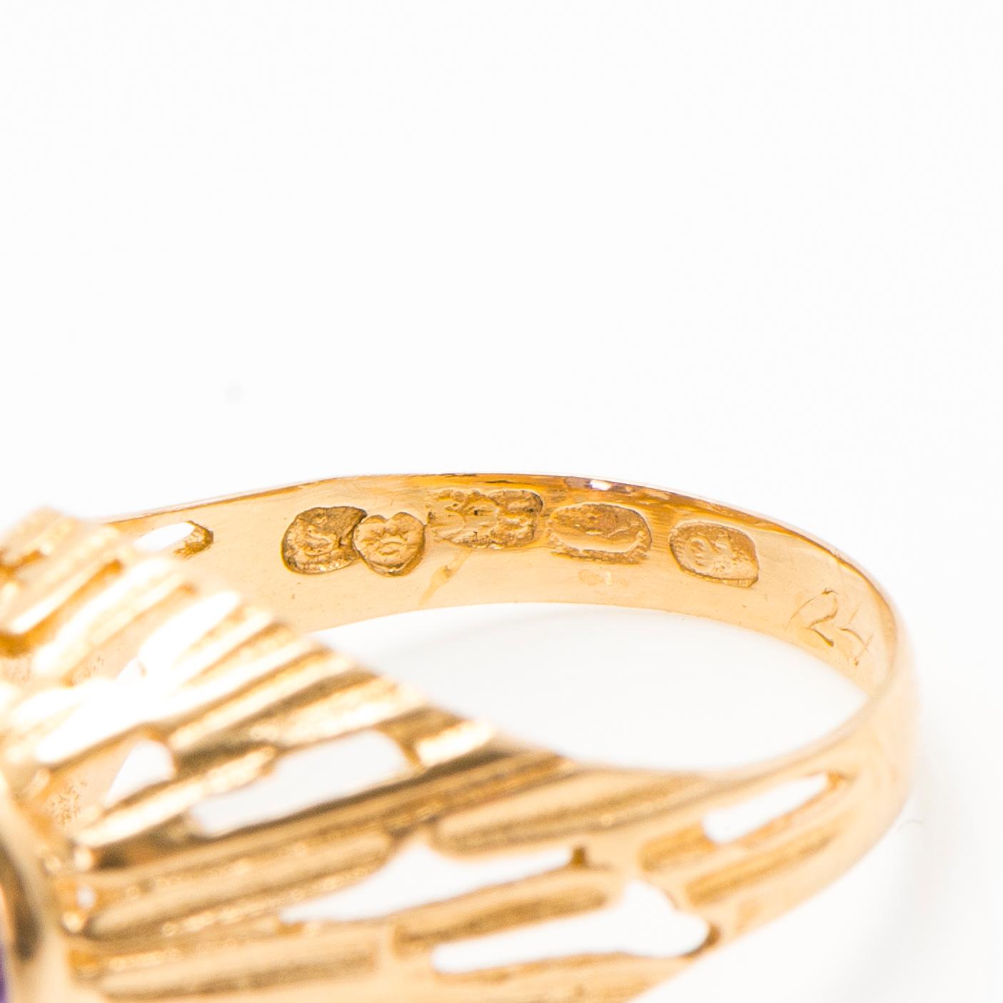 A set of 14K gold earrings and a ring with amethysts.