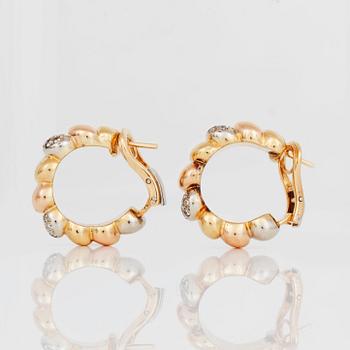 A pair of tricolor gold and diamond earrings.
