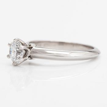 Tiffany & Co, A platinum ring with a 0.65 ct diamond.