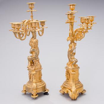 Two similar mid 19th century candelabra in gilt bronze,