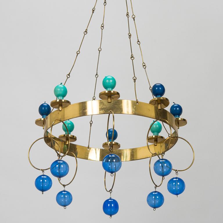 Kaija Aarikka, A 1960s/1970s brass mobile candelabra by Aarikka with candles by Timo Sarpaneva.