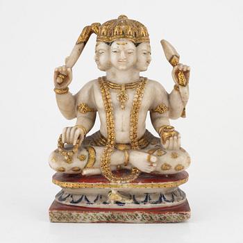 An alabaster sculpture of an deity with six heads and four arms, India, 19th Century.