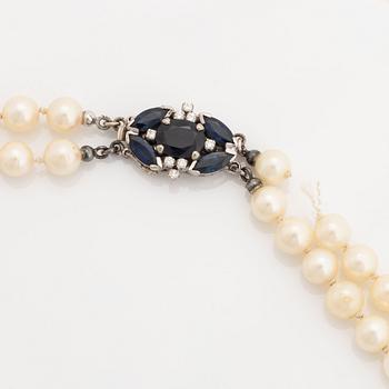Two strands cultured pearl necklace,  clasp 18K white gold with sapphires and brilliant cut diamonds.