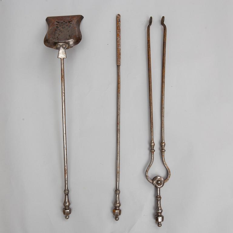 A set of three steel fire irons, 19th century.