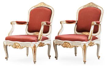 423. A pair of Rococo 18th century armchairs.