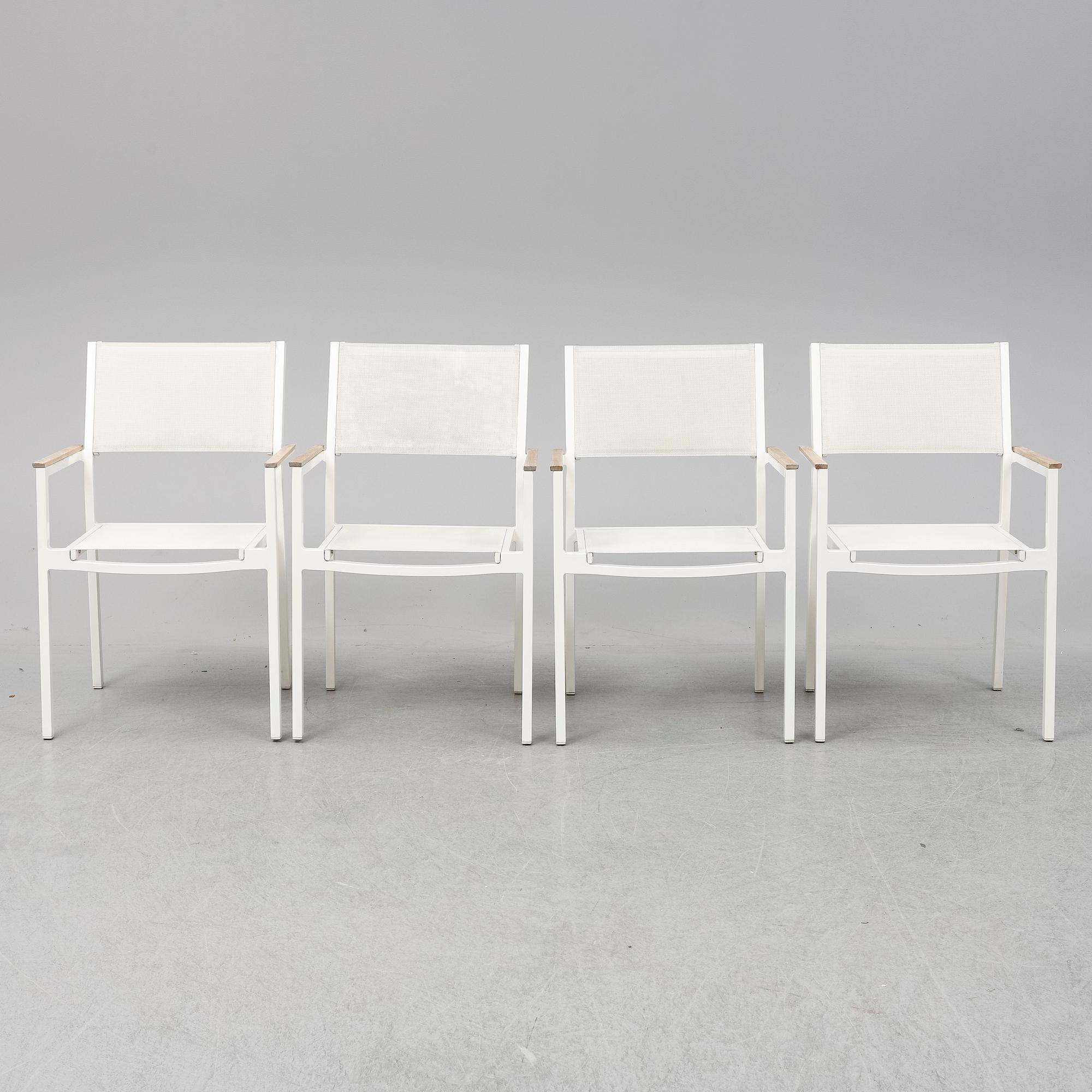 A garden table with four chairs, Gloster.
