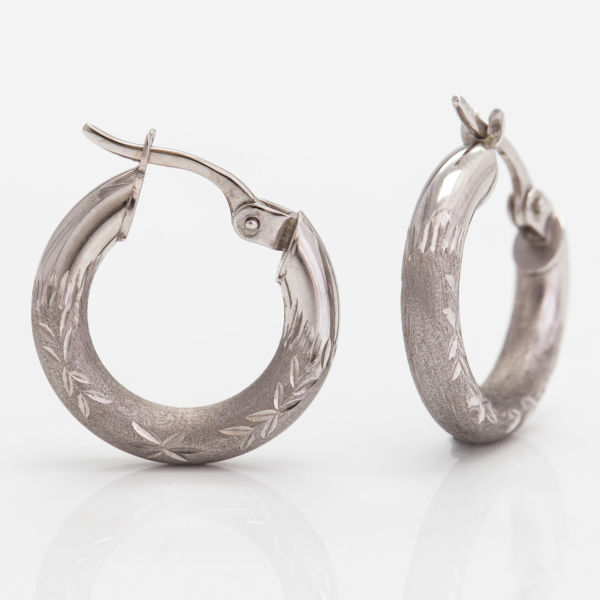 A pair of 14K white gold earrings.