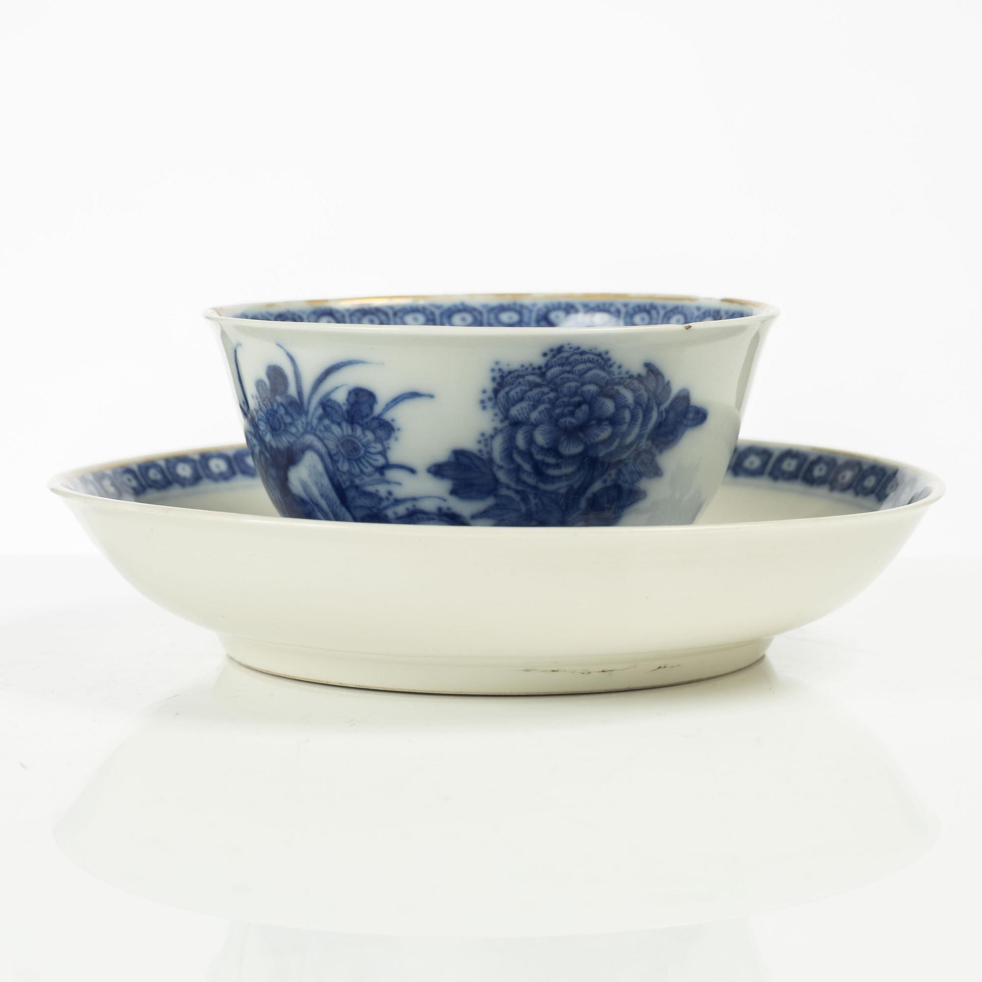A Chinese soft paste cup with saucer, Qing dynasty, 18th century.