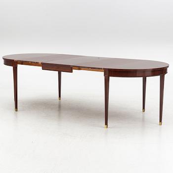 An Empire style dining table and ten chairs, second half of the 20th Century.