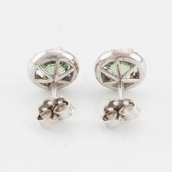 A pair of 18K gold earrings with green faceted sapphires and round brilliant-cut diamonds.