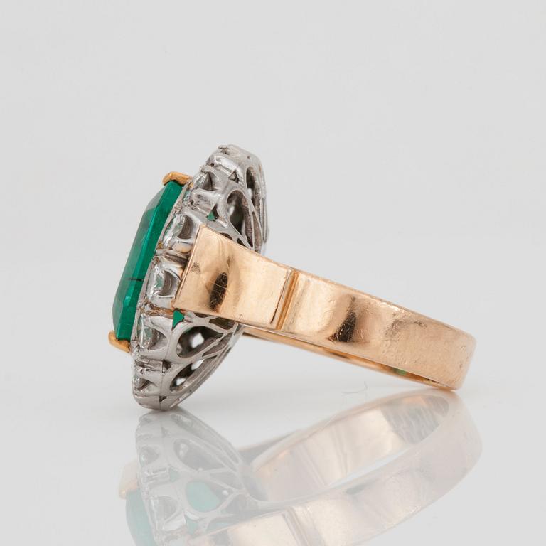 An emerald-cut emerald and brilliant-cut diamond ring.