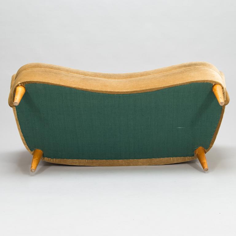 A mid-20th-century sofa and armchair.
