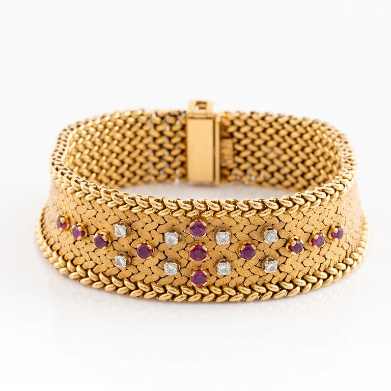 An 18K gold bracelet set with round brilliant-cut diamonds and rubies.