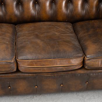 A leather upholstered Chesterfield sofa, England, second part of the 20th Century.