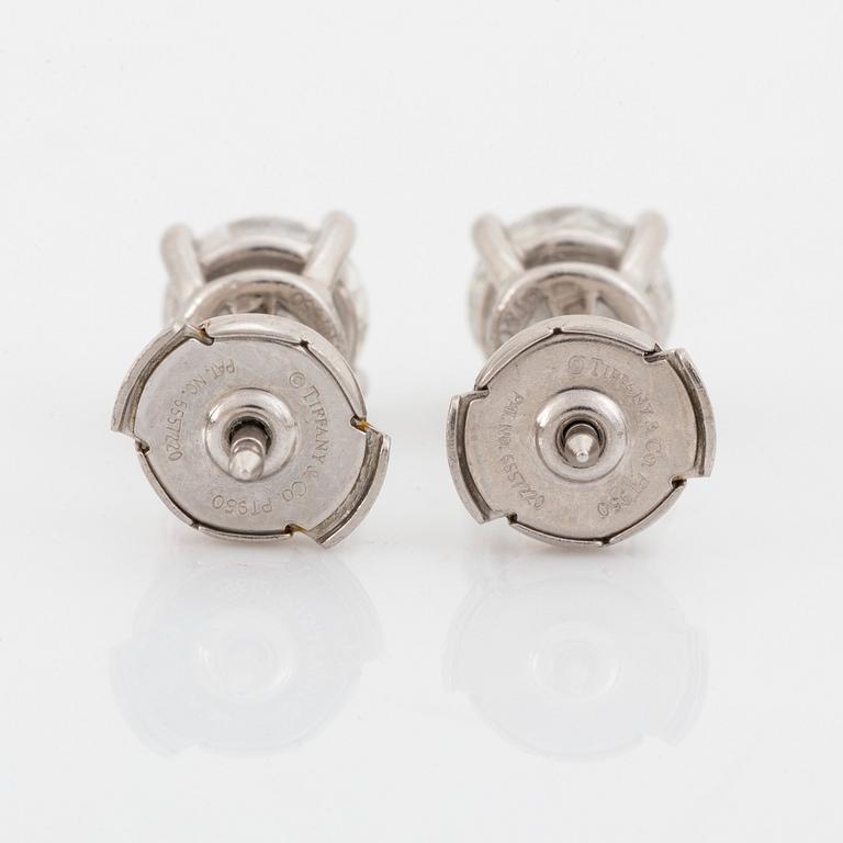 A pair of Tiffany solitaire diamond stud earrings in platinum.