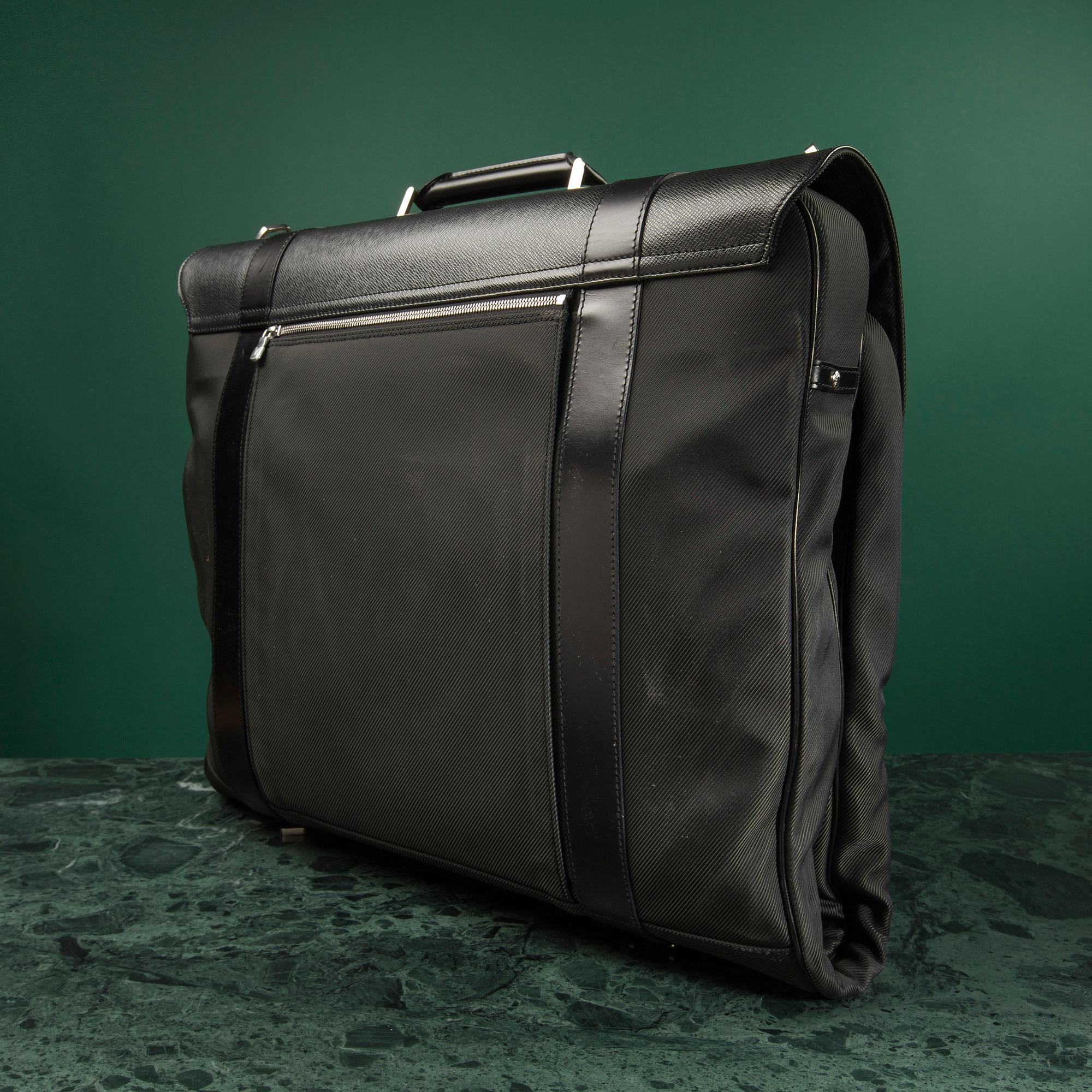 A Garment bag by Louis Vuitton.