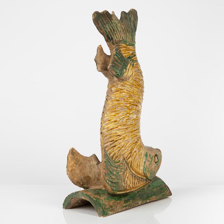 A green and yellow glazed roof tile figure of a fish, Ming dynasty (1368-1644).