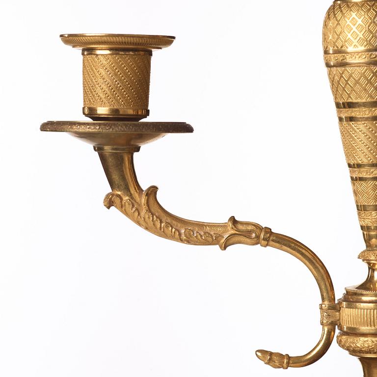 A pair of Empire early 19th century gilt bronze four-light candelabra.