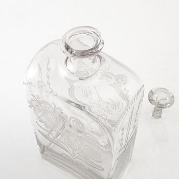 Brännvinsflaska, glas. Daterad Broby 1856.