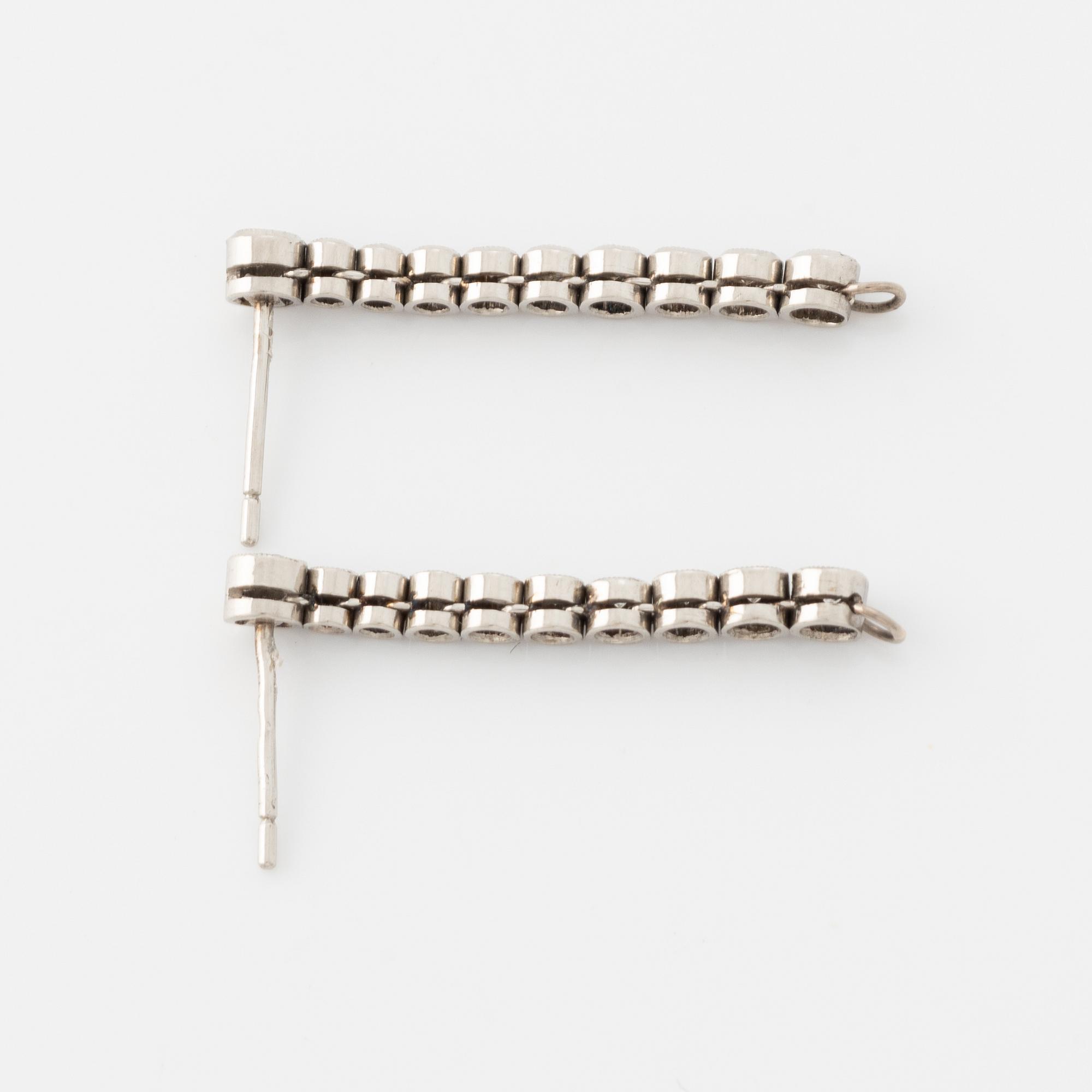 Platinum and brilliant cut diamond line earrings.