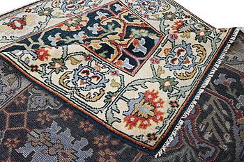 An oriental carpet with Mamluk design, c. 308 x 250 cm.