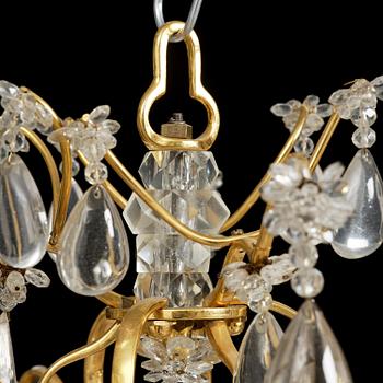 A near pair of Franch Louis-XV-style nine-branch gilt bronze and rock crystal chandeliers, later part 19th century.