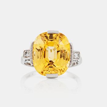 1111. A circa 13.50 ct fancy yellow sapphire and brilliant-cut diamond ring. Total carat weight of diamonds circa 0.10 ct.
