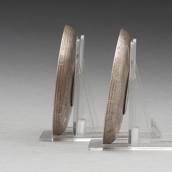 A set of two coasters with Chinese silver coins, 20th Century.