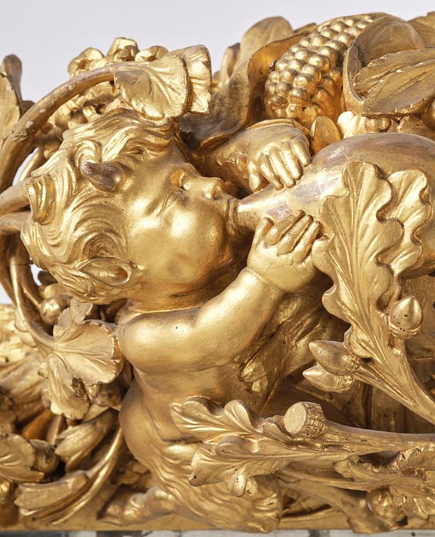 A presumably Dutch Louis XIV carved giltwood frame with mirror glass, in the style of Jean Le Pautre, late 17th century.