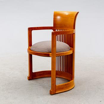 A cherry wood model 606 'Barrel' chair by Frank Lloyd Wright from Cassina.