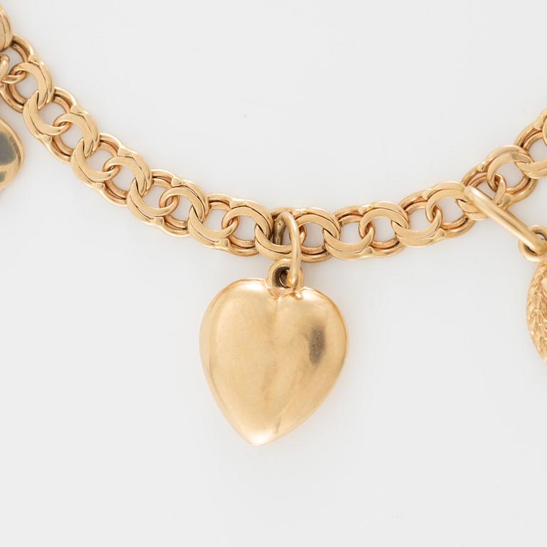 Armband 18K guld med berlocker.