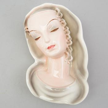 A late 1930s porcelain Goldscheider wall mask, model 7894, marked "Goldscheider Wien" and Made in Germany.