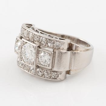 A platinum ring set with round brilliant and old-cut diamonds.