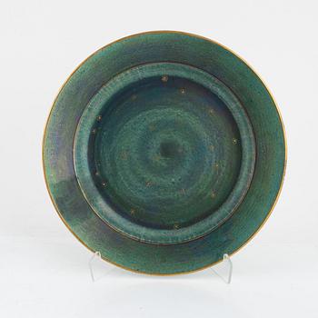 Josef Ekberg, 11 ceramic side plates and a dish, Gustavsberg, 1920's.