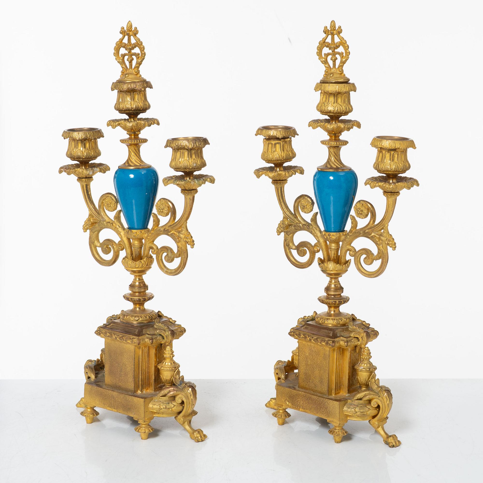 A French Louis XVI-style mantel clock and a pair of candelabra, late 19th Century.