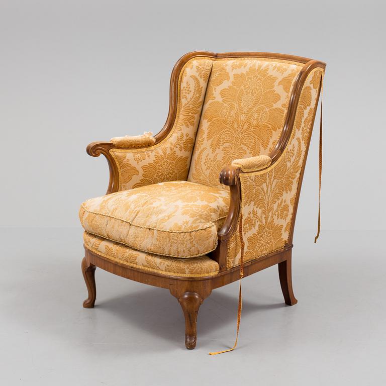 A Rococo style wing chair, first half of teh 20th Century.