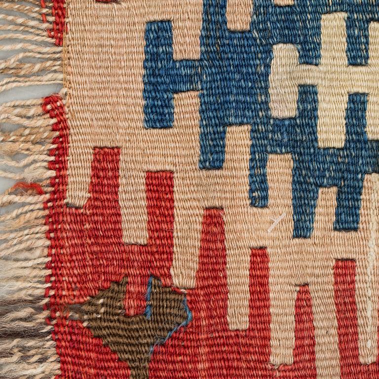 An antique Anatolian kilim fragment in form of a drape, around 232 x 76 cm.